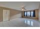 Spacious living room with tile floors, ceiling fan, and natural light from a large window at 3200 Charter Club Dr # A1, Tarpon Springs, FL 34688