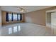 Bright living room with tile flooring, a ceiling fan, and wide windows at 3200 Charter Club Dr # A1, Tarpon Springs, FL 34688