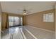 Living room with tile flooring, sliding glass doors, and ceiling fan at 3200 Charter Club Dr # A1, Tarpon Springs, FL 34688