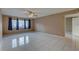 Bright and airy living room with tile floors, neutral walls, a ceiling fan, and natural lighting at 3200 Charter Club Dr # A1, Tarpon Springs, FL 34688