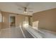 Spacious main bedroom featuring tile flooring, ceiling fan and view into attached bathroom at 3200 Charter Club Dr # A1, Tarpon Springs, FL 34688
