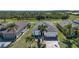 An aerial view showing the neighborhood, with lush landscaping, mature trees, and neighboring homes at 328 Siena Vista Pl, Sun City Center, FL 33573