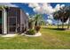 Landscaped backyard featuring a screened-in lanai with a view of the golf course at 328 Siena Vista Pl, Sun City Center, FL 33573
