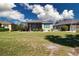 Expansive backyard featuring a screened-in lanai and lush green lawn at 328 Siena Vista Pl, Sun City Center, FL 33573
