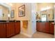 Bathroom with double vanity, dark countertops, and framed mirrors at 328 Siena Vista Pl, Sun City Center, FL 33573