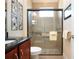 Bathroom with glass shower, granite vanity, and neutral tile at 328 Siena Vista Pl, Sun City Center, FL 33573