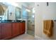Bathroom with glass shower, granite vanity, and neutral tile at 328 Siena Vista Pl, Sun City Center, FL 33573