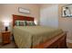 Bedroom with a wood frame bed, wood floors, and a double closet at 328 Siena Vista Pl, Sun City Center, FL 33573