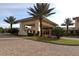 View of the community clubhouse entrance with manicured landscaping and paved entryway at 328 Siena Vista Pl, Sun City Center, FL 33573