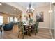 Formal dining room with a chandelier, wood table, and comfortable chairs, open to the living area at 328 Siena Vista Pl, Sun City Center, FL 33573