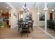 Bright dining room featuring modern chandelier, wood table, and accent wall mirrors at 328 Siena Vista Pl, Sun City Center, FL 33573