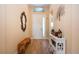 Inviting foyer with a wood-look flooring, decorative mirror, and a charming console table at 328 Siena Vista Pl, Sun City Center, FL 33573