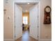 Inviting hallway with an antique clock, leading into a well-lit room with wood floors at 328 Siena Vista Pl, Sun City Center, FL 33573