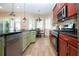 Open kitchen with stainless steel appliances, ample counter space and a view of the breakfast nook at 328 Siena Vista Pl, Sun City Center, FL 33573