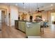 Open kitchen features stainless appliances, island with seating, and a view of the living room at 328 Siena Vista Pl, Sun City Center, FL 33573