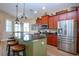 Bright kitchen features a granite island with seating and stainless steel appliances at 328 Siena Vista Pl, Sun City Center, FL 33573