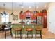 Kitchen features stainless steel appliances, a center island with bar stool seating, and cherry cabinets at 328 Siena Vista Pl, Sun City Center, FL 33573