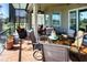 Relaxing screened lanai with comfortable seating, ceiling fan, and outdoor view at 328 Siena Vista Pl, Sun City Center, FL 33573