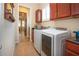 Laundry room features a front load washer and dryer and lots of cabinet space at 328 Siena Vista Pl, Sun City Center, FL 33573