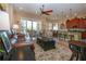 Open-concept living area with a ceiling fan that flows into a kitchen with barstool seating at 328 Siena Vista Pl, Sun City Center, FL 33573