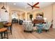 Bright living room with a leather sofa, ceiling fan, archways to dining room, and a decorative painting at 328 Siena Vista Pl, Sun City Center, FL 33573