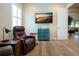 Comfortable living room featuring hardwood floors, natural lighting, and stylish decor at 328 Siena Vista Pl, Sun City Center, FL 33573