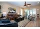 Spacious living room featuring neutral paint, ceiling fan, and sliding glass doors leading to the lanai at 328 Siena Vista Pl, Sun City Center, FL 33573