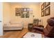 Cozy living room featuring hardwood floors, ample seating, and a gallery wall at 328 Siena Vista Pl, Sun City Center, FL 33573