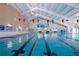 Bright indoor pool with lane dividers offers a dedicated swimming space for fitness and recreation at 328 Siena Vista Pl, Sun City Center, FL 33573