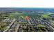 Aerial view of a well-planned community with homes nestled amidst farmland and lakes at 3301 San Moise Pl, Plant City, FL 33567