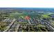 Beautiful aerial view of a residential area with large farm fields beyond the neighborhood and mature trees at 3301 San Moise Pl, Plant City, FL 33567
