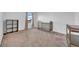 Bedroom with neutral carpet, shelving and a crib by the window with natural light at 3301 San Moise Pl, Plant City, FL 33567