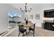 Bright dining area with chandelier, table and access to outdoor patio with sliding glass doors providing ample natural light at 3301 San Moise Pl, Plant City, FL 33567