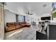 Open-concept living space boasting neutral walls, plush brown leather furniture, and an adjacent dining area at 3301 San Moise Pl, Plant City, FL 33567