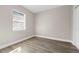 Comfortable bedroom with wood-look flooring, bright window, and closet for storage at 3512 E 23Rd Ave, Tampa, FL 33605