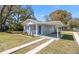 View of a one-story home showcasing a carport, refreshed exterior paint, and driveway at 3512 E 23Rd Ave, Tampa, FL 33605