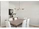 Bright dining room features modern chandelier, stylish furniture, and built-in bar area at 3618 W Royal Palm Cir, Tampa, FL 33629