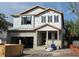 Two-story home featuring a concrete block exterior under construction with visible window frames and a covered entry at 3618 W Royal Palm Cir, Tampa, FL 33629
