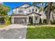 Charming two-story home featuring a well-maintained lawn, a two-car garage, and a welcoming front entrance at 3618 W Royal Palm Cir, Tampa, FL 33629