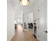 Bright hallway showcasing hardwood floors and white trim, leading to rooms filled with natural light at 3618 W Royal Palm Cir, Tampa, FL 33629