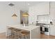 Eat-in kitchen features white countertops, an island with seating, and stainless steel appliances at 3618 W Royal Palm Cir, Tampa, FL 33629