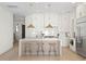 Bright, eat-in kitchen features an island, stainless appliances and white cabinetry at 3618 W Royal Palm Cir, Tampa, FL 33629