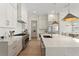 Kitchen features white cabinets, stainless steel appliances, and an eat-in island at 3618 W Royal Palm Cir, Tampa, FL 33629