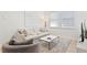Bright living room features neutral tones, stylish furniture, and ample natural light from the large windows at 3618 W Royal Palm Cir, Tampa, FL 33629