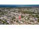 Aerial view of a large residential neighborhood next to a green inlet of the ocean at 4208 Woodfield Ave, Holiday, FL 34691