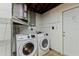 Laundry room featuring a new washer and dryer, shelving, and exterior door at 4208 Woodfield Ave, Holiday, FL 34691