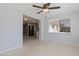 Bright living room with open layout, a ceiling fan, and view into the adjacent kitchen area at 4208 Woodfield Ave, Holiday, FL 34691