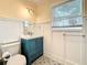 Powder room with patterned floor tile, wainscoting, and a vanity at 4827 7Th N Ave, St Petersburg, FL 33713