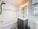 Bathroom with a tiled tub, modern vanity, and decorative floor tiles at 4827 7Th N Ave, St Petersburg, FL 33713