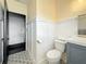 A bathroom featuring wainscoting, decorative tile flooring, and a modern vanity at 4827 7Th N Ave, St Petersburg, FL 33713